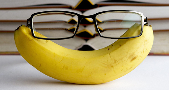 a banana with a pair of glasses perched on top