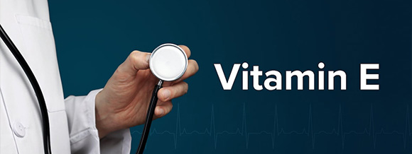 a doctor holding a stethoscope with the words Vitamin E next to it