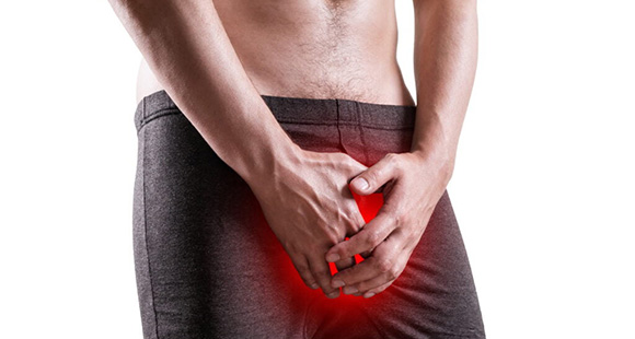 a man holding his groin after receiving trauma