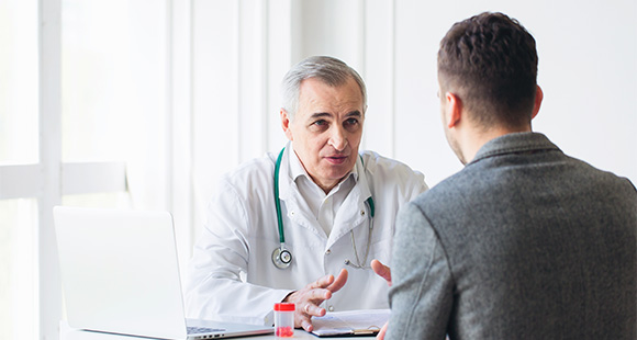 a senior doctor talking with a patient about plication